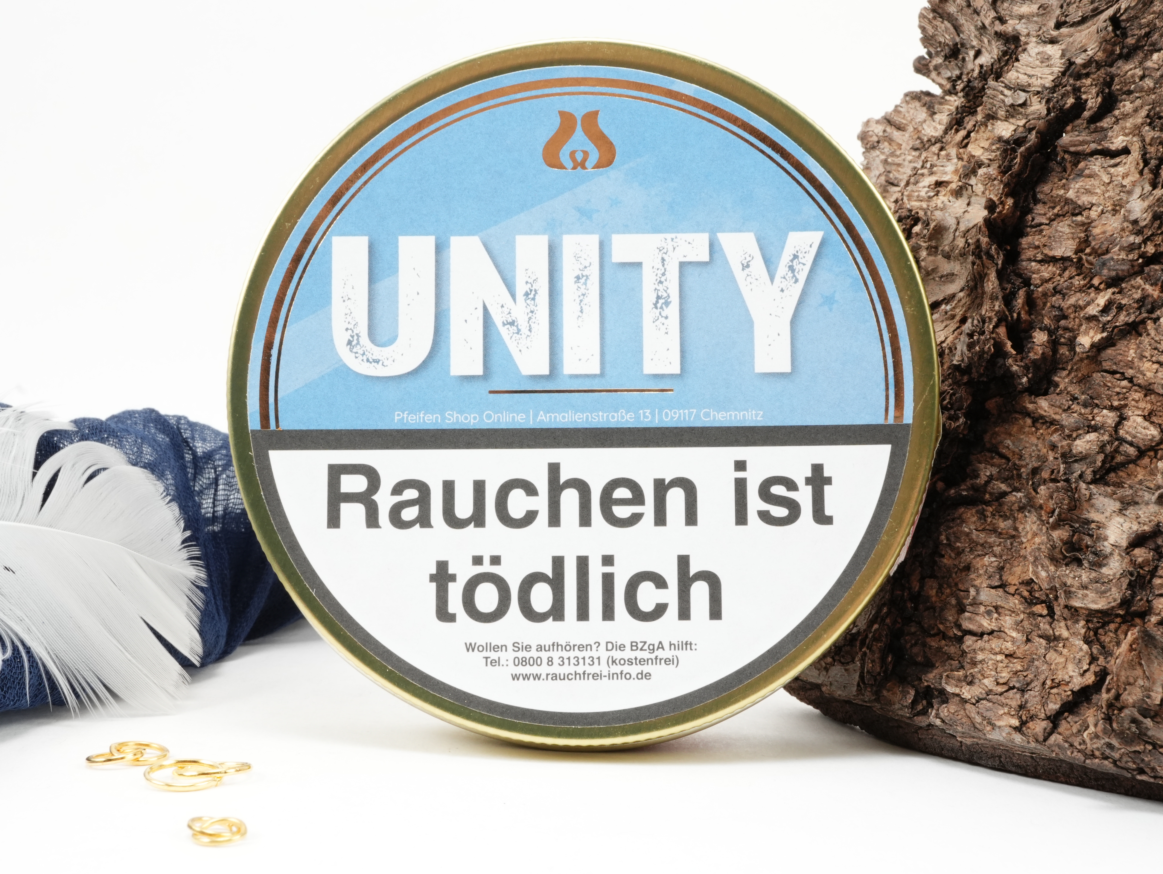 UNITY Pfeifentabak 50g Dose von oben mit daneben liegendem frischen Tabak und Dekoration
