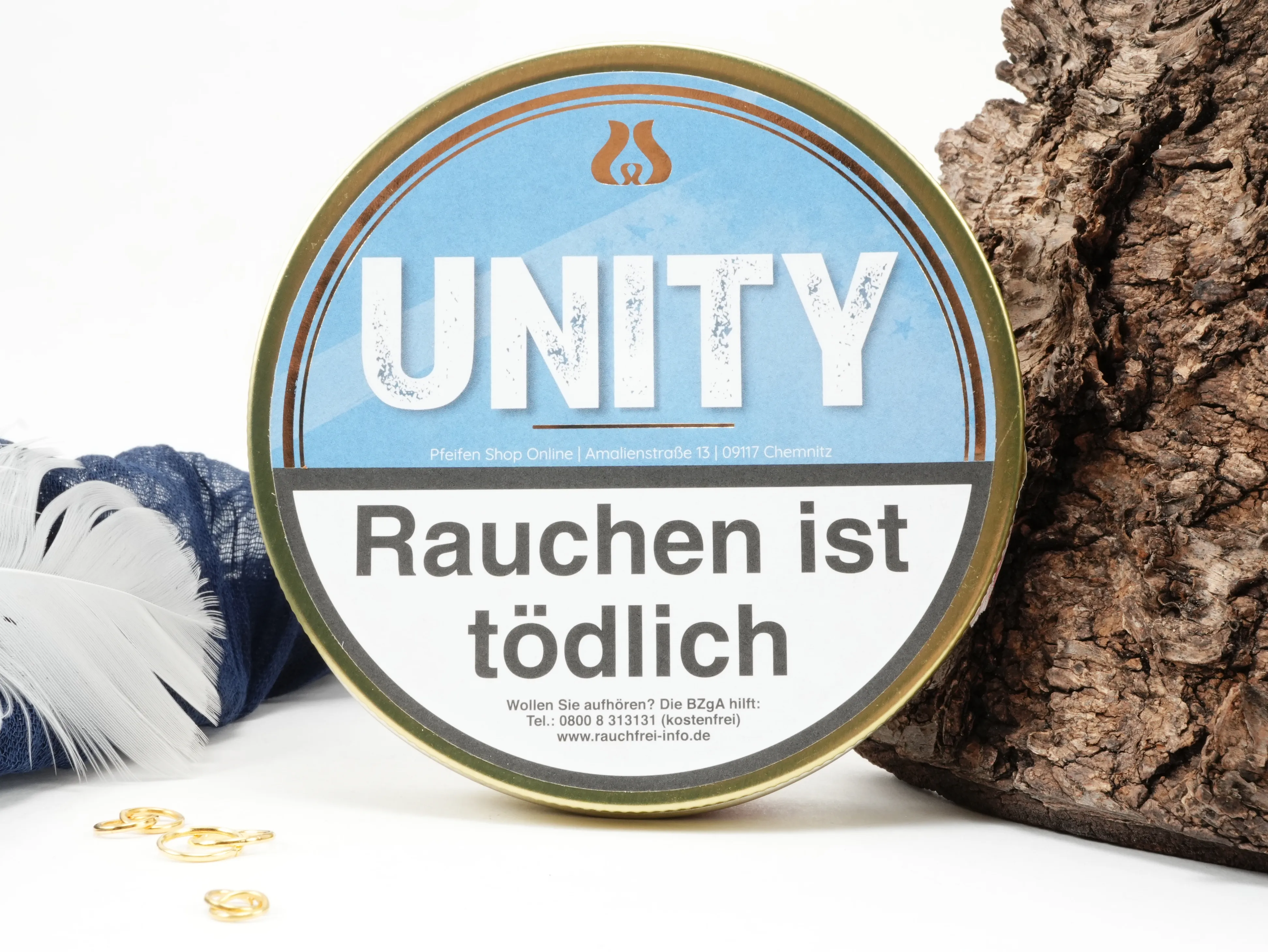 UNITY Pfeifentabak 50g Dose von oben mit daneben liegendem frischen Tabak und Dekoration