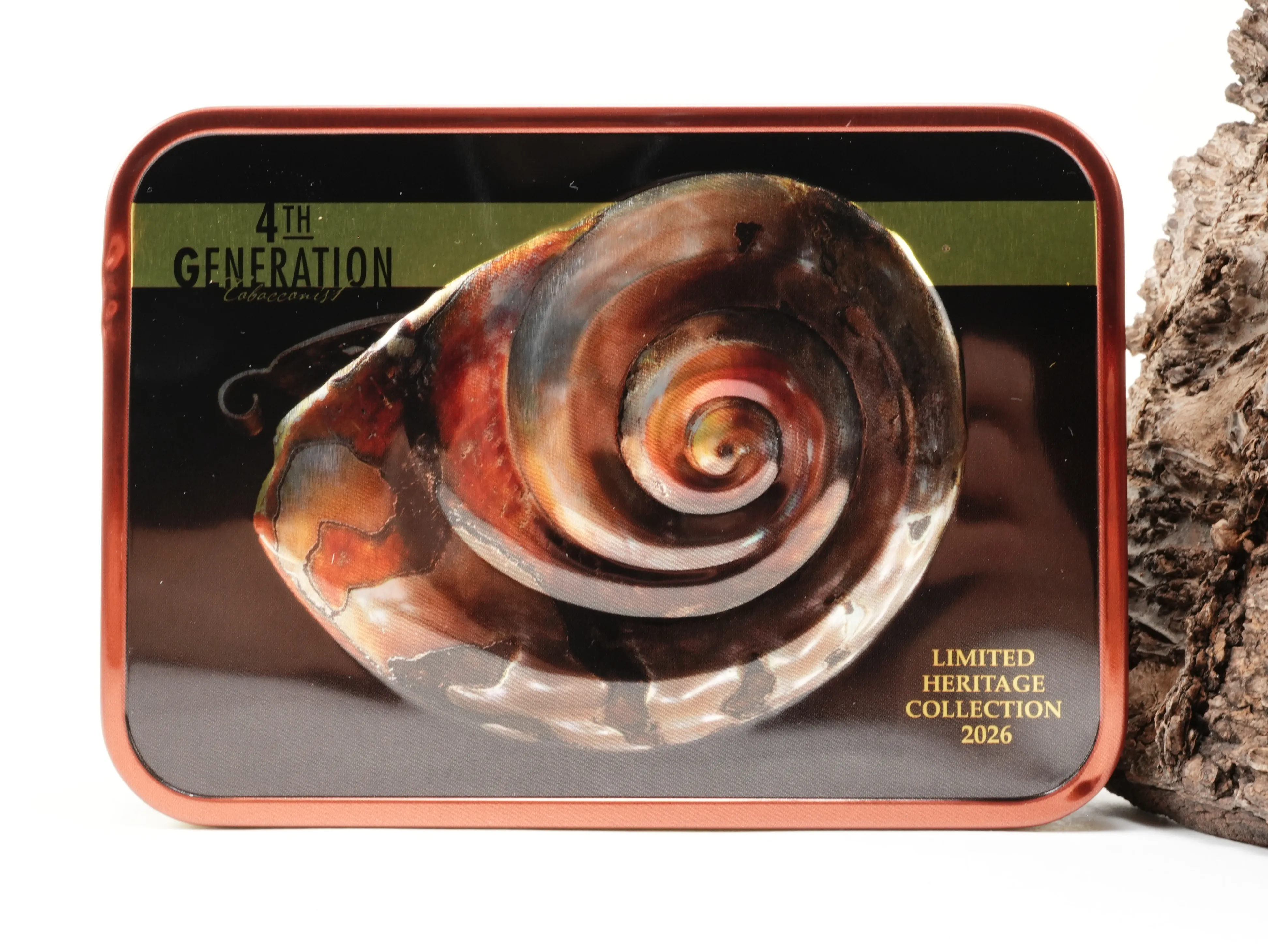 Rechteckige kupferfarbene 4th Generation Limited Heritage Collection 2026 Tabakdose mit Sea Shell Pipe Motiv vor Baumrinde – Titelbild