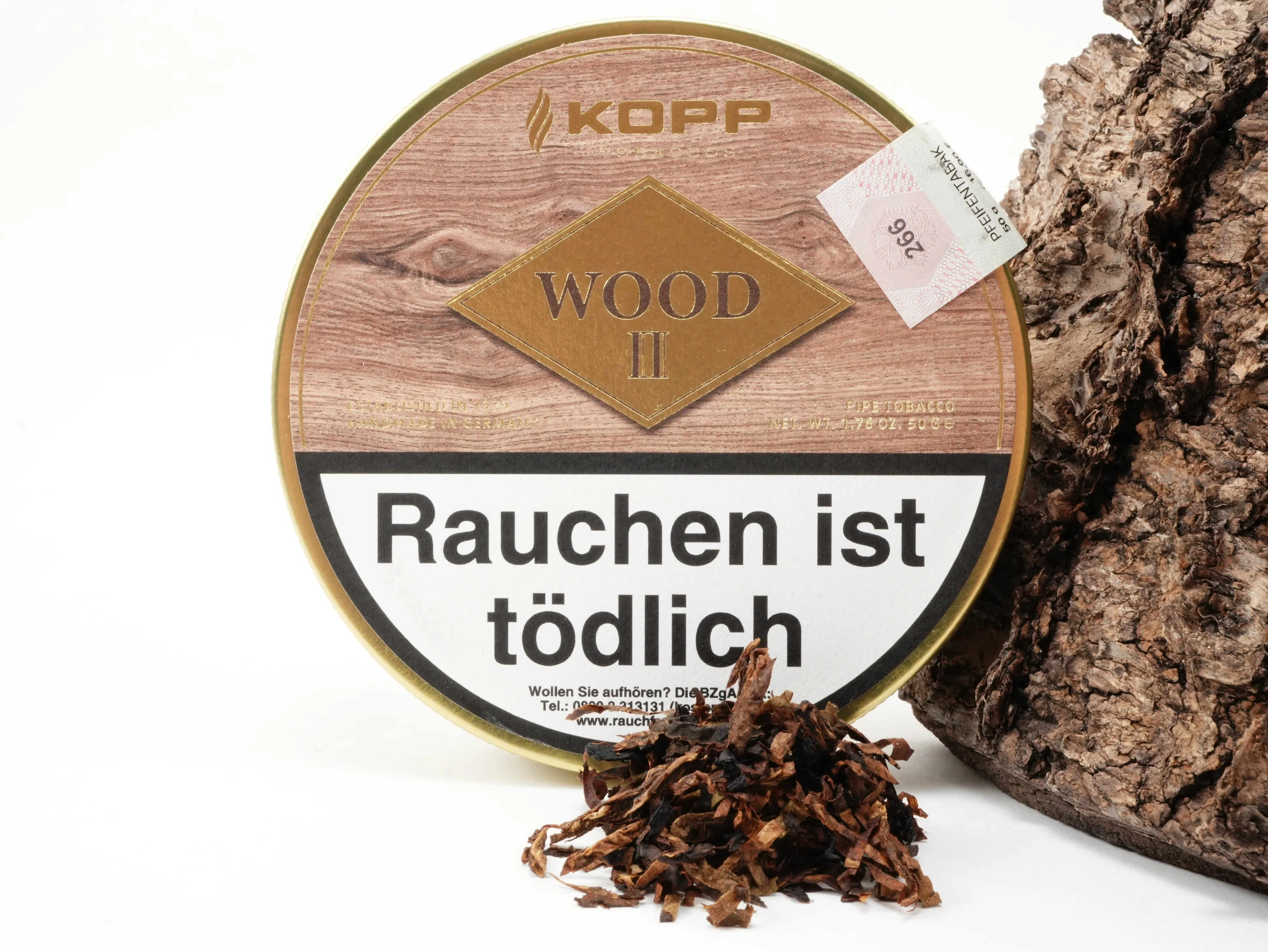 Kopp Wood II Tabakdose im Hintergrund mit präsentiertem Tabak-Blend im Vordergrund
