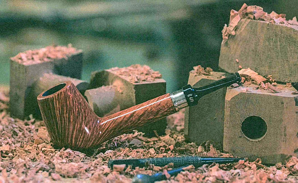 Mood Bild einer Stanwell Jahrespfeife auf Holzspänen an eine Bruyère Block