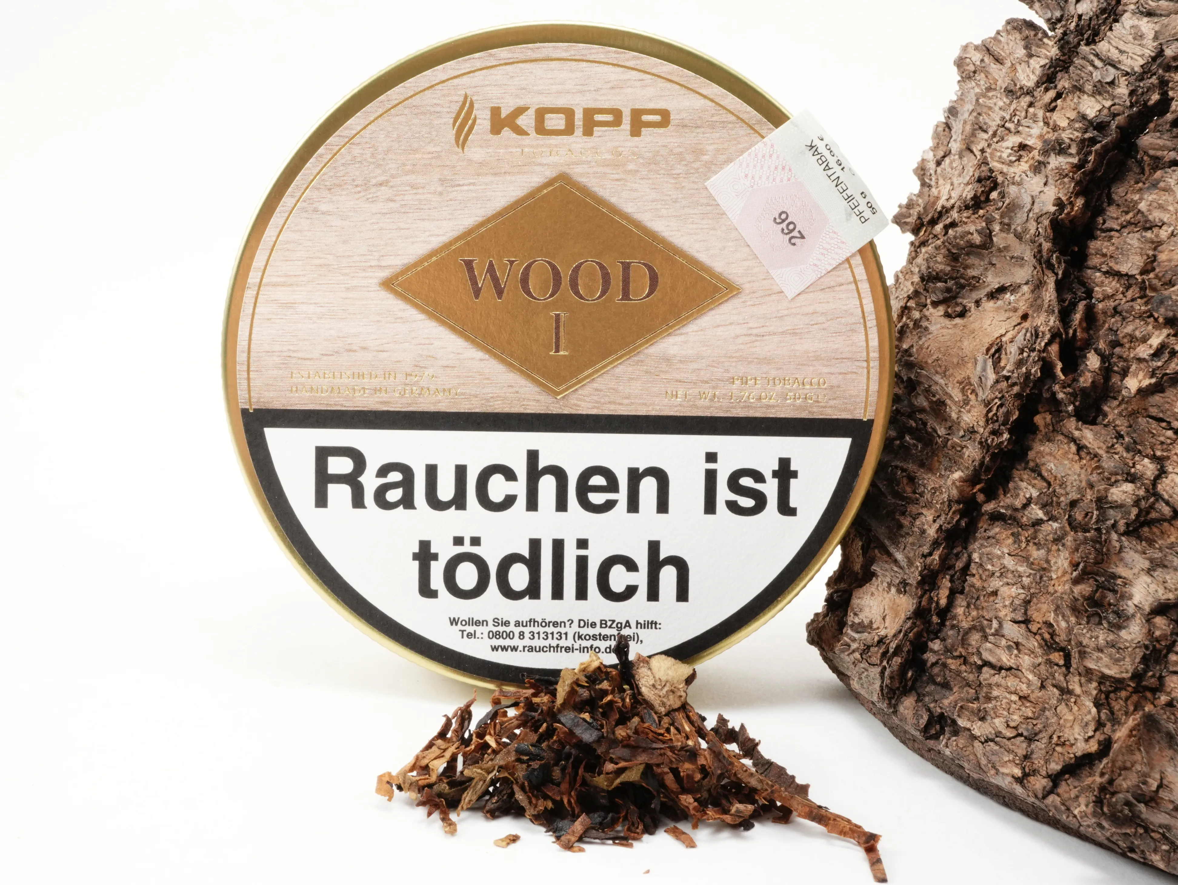 Kopp Wood I Tabakdose im Hintergrund mit präsentiertem Tabak-Blend im Vordergrund
